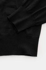 Gran Sasso Fine-knit crew neck sweater black shown from above, highlighting ribbed cuffs, fine knit, regular fit, crew neckline, lightweight feel, and softness from virgin wool, cashmere, and silk.