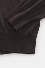 Gran Sasso Fine knit crew neck sweater dark brown shown close-up from above, highlighting ribbed cuffs, regular fit, lightweight, very soft mix of virgin wool, cashmere, and silk with a very fine knit pattern and crew neckline.