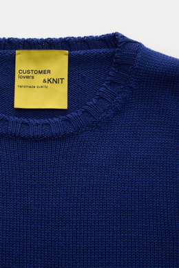Close-up front top view of B.F. Knitwear Merino crew neck jumper dark blue, showing pure merino wool, soft feel, semi chunky knit, slim fit, crew neck, rib knit bands.