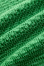 Close-up front view of the green B.F. Knitwear Merino crew neck jumper showing semi chunky knit texture, pure merino wool, soft feel, slim fit, rib knit bands, and crew neck.