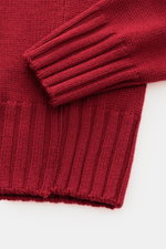 Close-up top-down view of the B.F. Knitwear Merino crew neck jumper red, showing pure merino wool, soft feel, semi chunky knit, slim fit, crew neck, and rib knit bands.