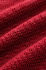 Close-up top-down view of the B.F. Knitwear Merino crew neck jumper red showing semi chunky knit texture, pure merino wool, soft feel, slim fit, crew neck, and rib knit bands.