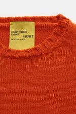 Close-up front view of B.F. Knitwear Merino crew neck jumper orange showing rib knit bands and label, pure merino wool, soft feel, semi chunky knit, slim fit, crew neck.