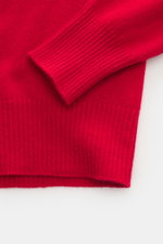 Close-up top-down view of B.F. Knitwear Cashmere crew neck sweater red showing elastic ribbed cuffs and medium-fine knit.