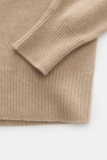 B.F. Knitwear Cashmere crew neck beige shown from close-up top view, highlighting elastic ribbed cuff, soft touch, medium-fine knit.