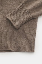 Close-up, top-down view of the B.F. Knitwear Cashmere crew neck sweater taupe melange sleeve and ribbed cuff showing soft, medium-fine knit pattern.

Description: <p>Autumnal cashmere from the knitting expert B.F. KNITWEAR: This softly knitted crew neck s