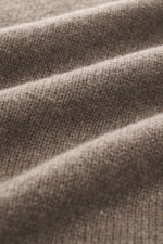 Close-up, angled view of B.F. Knitwear Cashmere crew neck sweater taupe melange showing soft, medium-fine knit pure cashmere fabric.