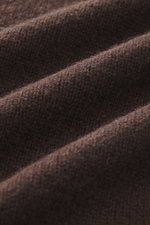 Close-up fabric texture of B.F. Knitwear Cashmere crew neck sweater dark brown, showing medium-fine knit pattern from a side angle.
