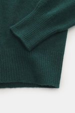 Close-up side view of B.F. Knitwear Cashmere crew neck sweater dark green showing elastic ribbed cuffs, pure cashmere, and medium-fine knit.