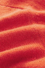 Close-up front view of the softly knitted orange B.F. Knitwear Cashmere crew neck sweater showing medium-fine knit pattern and texture.