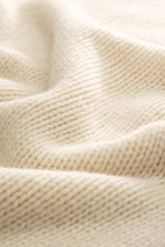 Close-up front view of B.F. Knitwear Cashmere crew neck sweater cream showing soft, pure cashmere with medium coarse knit and elastic ribbed cuffs, perfect for autumn.