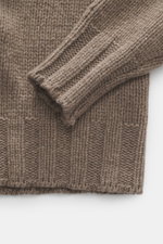 Close-up top-down view of the taupe B.F. Knitwear Cashmere crew neck sweater showing elastic ribbed cuffs and medium coarse knit pattern, pure cashmere, soft touch, regular fit. Autumnal cashmere from the knitting expert B.F. KNITWEAR: This softly knitted
