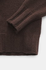 Close-up top-down view of B.F. Knitwear Cashmere crew neck sweater dark brown sleeve showing medium coarse knit, elastic ribbed cuffs, and soft pure cashmere texture.