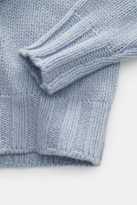 Close-up top-down view of the B.F. Knitwear Cashmere crew neck sweater light blue melange showing the soft, medium coarse knit pattern and elastic ribbed cuffs.

Description: Autumnal cashmere from the knitting expert B.F. KNITWEAR: This softly knitted cr