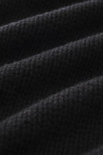 Close-up front view of B.F. Knitwear Cashmere crew neck sweater black showing medium coarse knit pattern and soft texture.