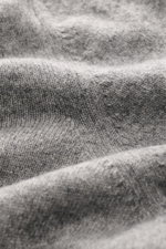 Close-up angled view of Aida Barni Cashmere crew neck jumper grey melange showing fine knit pattern and soft texture.
