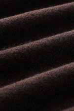 Close-up front view of the fine knit pattern on the dark brown Aida Barni Cashmere crew neck jumper showcasing its soft, pure cashmere fabric.

<p>Luxury-class essential: The Italian label AIDA BARNI processes premium cashmere in this timeless crewneck sw