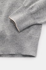 Close-up front view of Brunello Cucinelli Cashmere pullover grey melange showing fine knit texture, smooth pure cashmere, and contrast edges.

<p>This timeless and versatile finely knit crew neck sweater by BRUNELLO CUCINELLI is made from pure cashmere, f