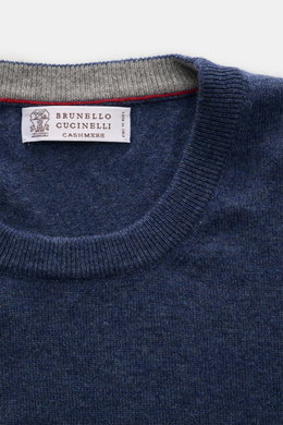 Close-up front view of Brunello Cucinelli Cashmere pullover grey blue melange crew neck, showing fine knit texture, pure cashmere, narrow contrast edges, and rib-knit cuffs.