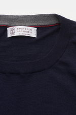 Close-up top-down view of Brunello Cucinelli Fine-knit crew-neck pullover navy showing label, smooth wool and cashmere knit, and fine texture.

<p>This timeless, versatile sweater by BRUNELLO CUCINELLI is made from the finest wool and cashmere knit, featu