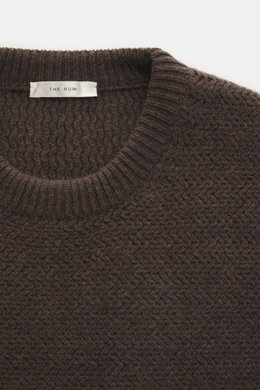 Close-up front view of The Row Crewneck sweater 'Anish' gray-brown melange showing textured pearl knit, crew neckline, and soft ribbed cuffs.