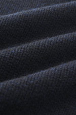 Close-up fabric detail of The Row Cashmere crewneck sweater 'Markhim' navy melange, showing coarse knit pattern and soft texture from a front angle.