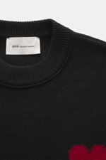 Ami Paris Crew neck jumper black shown from a close-up top-down perspective, highlighting ribbed crew neck and fabric texture.  
<p>Stylish basic: This crew neck jumper with a casual cut and an XXL logo intarsia made from pure virgin wool is an enduring c
