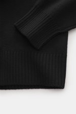 Alt tag (125 characters max):
Close-up of Ami Paris Crew neck jumper black showing ribbed elasticated cuff and hem from a top-down angle.

Description:
<p>Stylish basic: This crew neck jumper with a casual cut and an XXL logo intarsia made from pure virgi