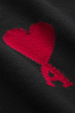 Close-up front view of Ami Paris Crew neck jumper black showing the large red Ami de Cœur intarsia on soft black virgin wool knit.

<p>Stylish basic: This crew neck jumper with a casual cut and an XXL logo intarsia made from pure virgin wool is an endurin