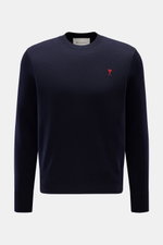 Front view of the Ami Paris Merino Crewneck Sweater Navy, made of pure merino wool with soft touch, fine knit, regular fit, crew neckline, red logo stitching on chest, and ribbed cuffs. 

<p>Timeless basic: The AMI PARIS crewneck sweater made of pure meri