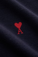 Close-up front view of Ami Paris Merino Crewneck Sweater Navy showing fine knit pattern, soft merino wool, and red heart logo stitching on chest.