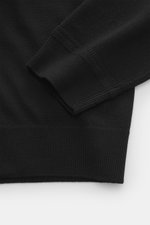 Close-up image of the sleeve and cuff of the Maison Kitsuné Crewneck Sweater 'Red Profile' black, photographed from above showing knit texture and ribbed details.

Description: <p>Cool essential by MAISON KITSUNÉ: With the typical fox stitching on the che