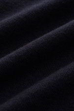 Close-up front view of the navy Kiefermann Merino Crewneck Sweater 'Marleys' showing pure Merino wool, soft touch, very fine knit, slim fit, and crew neckline.