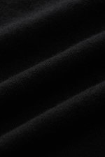 Close-up front view of Kiefermann Merino crew neck sweater 'Marleys' black showing its very fine knit pattern and soft pure merino wool texture.