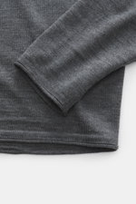 Close-up, top-down view of the sleeve and hem of the Kiefermann Merino fine knit sweater 'Benjaminn' dark grey melange, showing pure merino wool, super soft feel, very fine knit pattern, slim fit, round neckline, and open, rolled edge finishes.