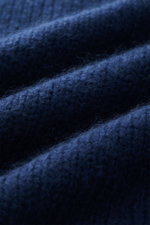 Close-up view of the dark blue Iris von Arnim Cashmere-silk crew neck sweater 'Felton' showing its mix of cashmere and silk, very soft feel, voluminous knit pattern, slim fit, crew neckline, and comfortable ribbed cuffs.