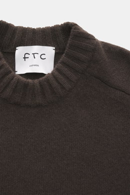 Nahaufnahme des FTC Cashmere Rundhalspullover dunkelbraun von oben, zeigt Rippbündchen, OEKO-TEX®-zertifiziert, Slim Fit, weiche Haptik.