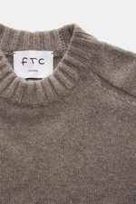Nahaufnahme des FTC Cashmere Rundhalspullover taupe meliert von oben, zeigt den weichen, mittelfeinen Strick mit Rippbündchen und Rundhalsausschnitt.