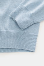 Close-up front view of the FTC Cashmere Crew Neck Sweater light blue showing fine knit pattern, ribbed cuffs, and crew neckline.