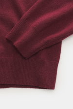 Close-up top view of the FTC Cashmere Crew Neck Sweater Bordeaux showing fine knit, ribbed cuffs, and soft pure cashmere fabric.