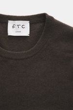 FTC Cashmere Crew Neck Sweater dark brown shown from above, highlighting pure cashmere, fine knit, slim fit, crew neckline, soft touch, ribbed cuffs.