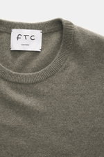 FTC Cashmere Crew Neck Sweater grey green shown from above, highlighting crew neckline, ribbed cuffs, pure cashmere, soft touch, fine knit, slim fit.