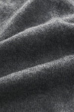 Close-up angled view of FTC Cashmere Crew Neck Sweater grey melange fabric showing fine knit pattern and soft texture.

Description: <p>The ultra-soft cashmere quality makes this timeless crew neck sweater from the sustainable knitwear label FTC CASHMERE 