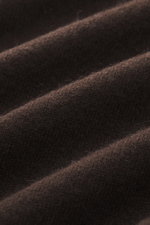 Close-up fabric texture of Moorer Cashmere crewneck sweater 'Orvieto-WY' dark brown, showing soft feel, fine knit, and plush fibers from a front angled perspective.
