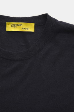 Close-up top-down view of the B.F. Knitwear Merino Crew Neck Sweater navy, featuring pure merino wool, soft feel, fine knit pattern, regular fit, crew neckline, and comfortable ribbed cuffs.