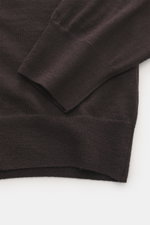 Close-up of the B.F. Knitwear Merino Crew Neck Sweater dark violet from above, showing pure merino wool, soft feel, fine knit pattern, regular fit, crew neckline, and comfortable ribbed cuffs.