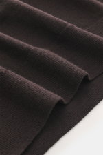 Close-up front view of B.F. Knitwear Merino Crew Neck Sweater dark violet fabric, showcasing pure merino wool, soft feel, fine knit pattern, regular fit, crew neckline, and comfortable ribbed cuffs.
