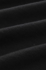 Close-up view of the B.F. Knitwear Merino Crew Neck Sweater black fabric showing pure merino wool with a soft feel, fine knit pattern, regular fit, crew neckline, and comfortable ribbed cuffs.