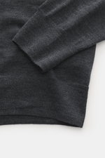 Close-up image from above showing the sleeve and bottom hem of the B.F. Knitwear Merino Crew Neck Sweater dark grey melange, made of pure merino wool with a soft feel, fine knit pattern, regular fit, crew neckline, and comfortable ribbed cuffs.