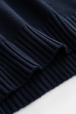 Close-up image from a slightly angled top view showing the ribbed cuffs of the navy 04651/ A trip in a bag Crew neck sweater 'Wintercotton Pocket Crew' made of a soft blend of cotton and wool with a medium-fine knit pattern, slim fit, crew neckline, contr